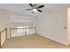 Upstairs area with a ceiling fan, neutral walls, carpet flooring, white railings, and a window view at 815 Marshview Close, Roswell, GA 30076