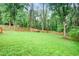Expansive, lush backyard with mature trees and wood fencing offering a private outdoor space at 1653 Terry Mill Se Rd, Atlanta, GA 30316