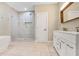 Bright bathroom with a modern aesthetic including double vanity sinks, a glass shower and tile floors at 1653 Terry Mill Se Rd, Atlanta, GA 30316