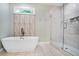 Beautiful bathroom featuring a freestanding tub, glass shower, decorative tile and a modern aesthetic at 1653 Terry Mill Se Rd, Atlanta, GA 30316