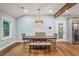 Traditional dining room features hardwood floors, wood table and upholstered bench seating and stylish pendant lighting at 1653 Terry Mill Se Rd, Atlanta, GA 30316