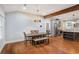 Bright dining room complemented by a breakfast bar, hardwood floors and stainless steel refrigerator at 1653 Terry Mill Se Rd, Atlanta, GA 30316