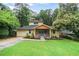 Charming two-story home featuring a lush lawn, covered porch, and attached garage at 1653 Terry Mill Se Rd, Atlanta, GA 30316