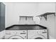 Bright laundry room features a modern washer and dryer with folding station, and a clean, neutral color palette at 1653 Terry Mill Se Rd, Atlanta, GA 30316