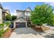 Rear exterior view of home featuring two-car garage, deck, and landscaped yard at 1741 Hickory Path Way, Suwanee, GA 30024