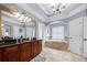 Luxurious bathroom featuring a jetted tub and custom tile work at 1741 Hickory Path Way, Suwanee, GA 30024