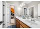 Bathroom featuring a double sink vanity with a view into an adjacent bedroom at 1741 Hickory Path Way, Suwanee, GA 30024