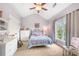 Bright bedroom features a vaulted ceiling, large window, and decorative furnishings at 1741 Hickory Path Way, Suwanee, GA 30024