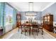 Formal dining room boasting hardwood floors, large window, and decorative chandelier at 1741 Hickory Path Way, Suwanee, GA 30024