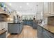 Well-appointed kitchen featuring an island with barstool seating and stylish lighting at 1741 Hickory Path Way, Suwanee, GA 30024