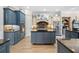 Modern kitchen with gray and white cabinets, stainless appliances, and granite countertops at 1741 Hickory Path Way, Suwanee, GA 30024