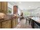 Bright kitchen featuring tan cabinets, granite counters and stainless steel appliances at 1741 Hickory Path Way, Suwanee, GA 30024