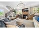 Comfortable living room featuring a fireplace, hardwood floors, and plenty of seating at 1741 Hickory Path Way, Suwanee, GA 30024