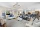 Open-concept living room with neutral tones and seamless flow to kitchen area at 1741 Hickory Path Way, Suwanee, GA 30024