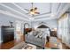 Comfortable main bedroom featuring a seating area and hardwood floors at 1741 Hickory Path Way, Suwanee, GA 30024
