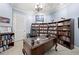 Home office featuring classic wood desk and shelving with library at 1741 Hickory Path Way, Suwanee, GA 30024