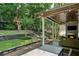 A covered outdoor patio features a stone fireplace and seating area, with string lights overhead at 2460 Drew Valley Ne Rd, Brookhaven, GA 30319