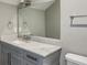 Elegant bathroom featuring a vanity with a marble countertop and framed mirror, complemented by modern fixtures at 2460 Drew Valley Ne Rd, Brookhaven, GA 30319