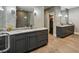Stylish bathroom with dual vanities, decorative mirrors, and a glass-enclosed shower at 2460 Drew Valley Ne Rd, Brookhaven, GA 30319