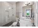 Modern bathroom features a glass shower, marble countertop, and updated fixtures at 2460 Drew Valley Ne Rd, Brookhaven, GA 30319