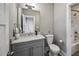 A well-lit bathroom with a marble countertop, vanity, and a shower/tub at 2460 Drew Valley Ne Rd, Brookhaven, GA 30319