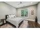Cozy bedroom with a ceiling fan, neutral walls, stylish rug, and plenty of natural light at 2460 Drew Valley Ne Rd, Brookhaven, GA 30319