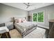 This bedroom features a neutral color palette, ceiling fan, a large window with natural light, and plush rug at 2460 Drew Valley Ne Rd, Brookhaven, GA 30319
