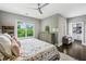 Comfortable bedroom features a ceiling fan, natural light, view, and walk-in closet with custom shelving at 2460 Drew Valley Ne Rd, Brookhaven, GA 30319