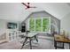 A bright bonus room features ample natural light, a hanging chair and ceiling fan, creating a cozy retreat at 2460 Drew Valley Ne Rd, Brookhaven, GA 30319