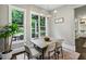 Cozy dining area featuring backyard views, a modern chandelier, and stylish decor elements at 2460 Drew Valley Ne Rd, Brookhaven, GA 30319