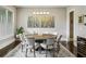 Sophisticated dining room with a modern chandelier, large windows, and seating for eight guests at 2460 Drew Valley Ne Rd, Brookhaven, GA 30319