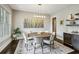 Elegant dining room with a large round table, stylish chandelier, and wine storage at 2460 Drew Valley Ne Rd, Brookhaven, GA 30319