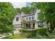 Charming two-story brick home boasts professionally landscaped front yard and a cozy front porch at 2460 Drew Valley Ne Rd, Brookhaven, GA 30319