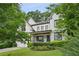 Charming two-story brick home featuring a beautifully landscaped front yard and inviting front porch at 2460 Drew Valley Ne Rd, Brookhaven, GA 30319