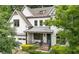 Beautiful two-story brick home boasting a welcoming front porch and meticulously maintained landscaping at 2460 Drew Valley Ne Rd, Brookhaven, GA 30319
