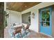 Inviting front porch with a porch swing, stylish decor, and a bright blue front door at 2460 Drew Valley Ne Rd, Brookhaven, GA 30319