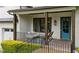 Close-up of a charming front porch with a porch swing and painted blue front door at 2460 Drew Valley Ne Rd, Brookhaven, GA 30319