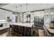 Stylish kitchen with stainless steel appliances, marble countertops, a center island, and dining area at 2460 Drew Valley Ne Rd, Brookhaven, GA 30319