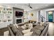 Open-concept living room with a fireplace, custom built-ins, and a staircase leading to the upper level at 2460 Drew Valley Ne Rd, Brookhaven, GA 30319