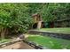 A backyard boasting a custom treehouse with a slide, providing a fun and adventurous play area at 2460 Drew Valley Ne Rd, Brookhaven, GA 30319