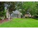 A home's backyard featuring lush green grass and trees at 4710 Vineyard Se Ct, Smyrna, GA 30082