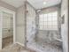 Modern primary bathroom showcasing glass shower and stone wall at 4710 Vineyard Se Ct, Smyrna, GA 30082