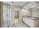Large bathroom with dual sinks, walk-in shower, and tile flooring at 4710 Vineyard Se Ct, Smyrna, GA 30082