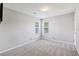 Neutral secondary bedroom with gray carpet and large windows for natural light at 4710 Vineyard Se Ct, Smyrna, GA 30082
