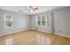 Sun-filled bedroom with hardwood flooring and ample natural light from large windows at 4710 Vineyard Se Ct, Smyrna, GA 30082