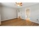 Bedroom with hardwood floors, a ceiling fan, and adjoining bathroom with a doorway at 4710 Vineyard Se Ct, Smyrna, GA 30082