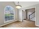 Charming dining room featuring hardwood floors, a vaulted ceiling, and large arched window at 4710 Vineyard Se Ct, Smyrna, GA 30082