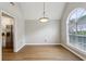 Open dining room with hardwood floors, a vaulted ceiling, and access to the kitchen at 4710 Vineyard Se Ct, Smyrna, GA 30082