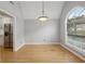 Dining room with hardwood flooring, large window, and doorway to kitchen area at 4710 Vineyard Se Ct, Smyrna, GA 30082