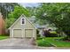 Charming exterior view of home with a two-car garage, manicured lawn, and attractive landscaping at 4710 Vineyard Se Ct, Smyrna, GA 30082